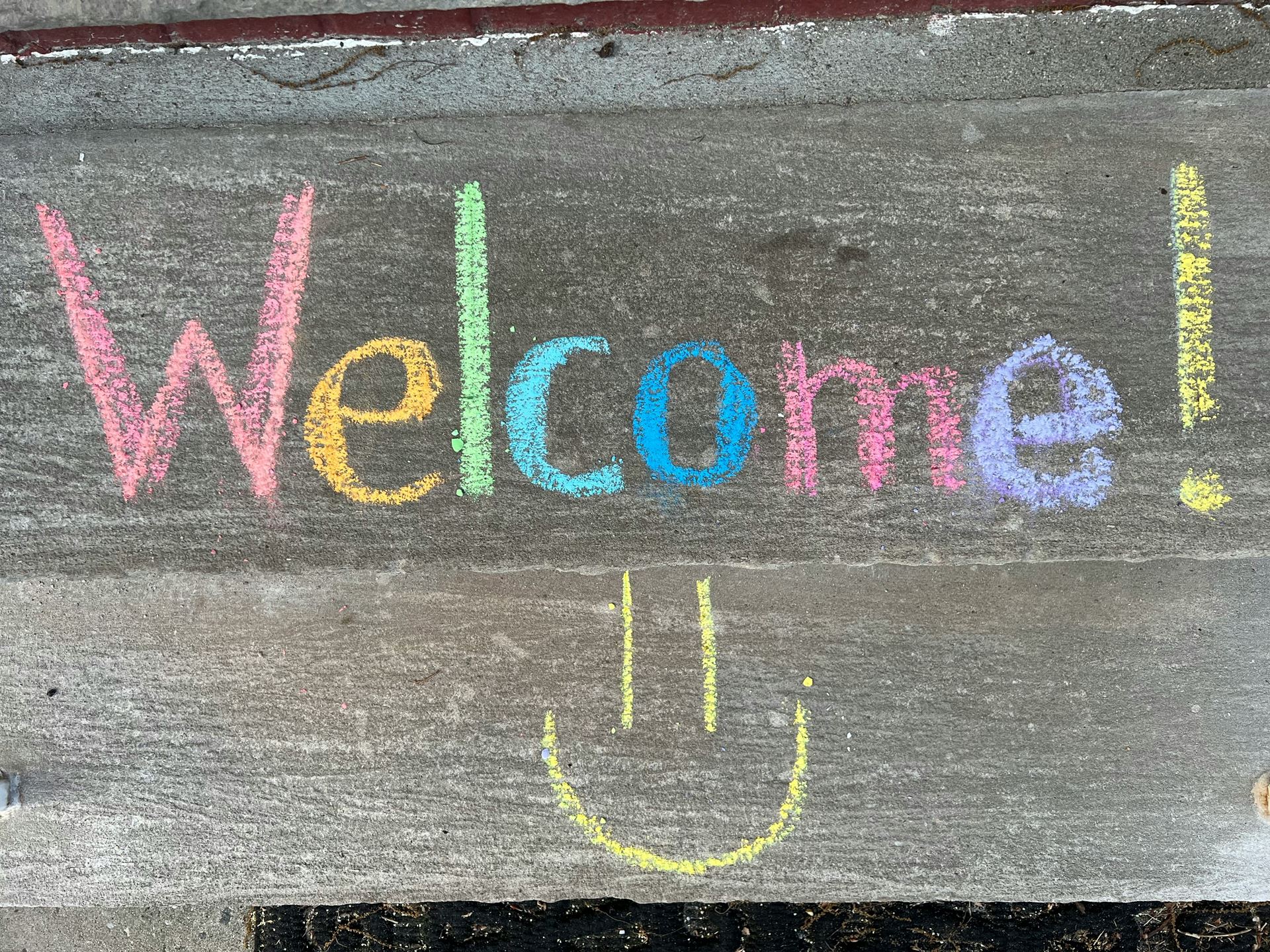 Welcome written in colourful chalk